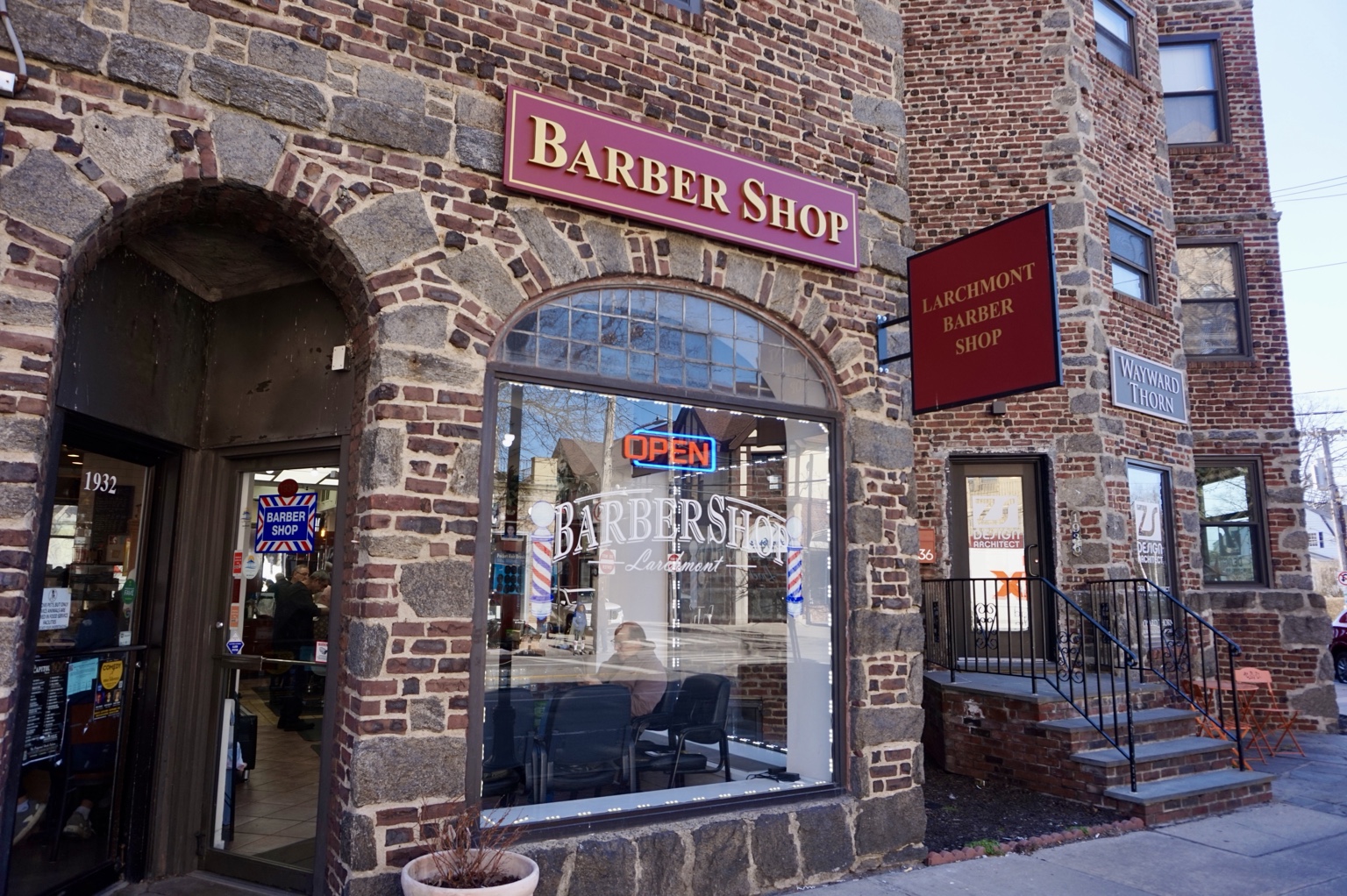 The brick and stone storefront of Larchmont Barber Shop on Palmer Avenue